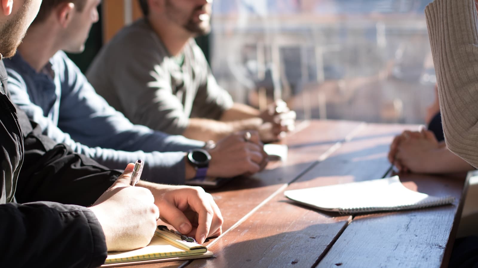 Volunteers around a table taking notes