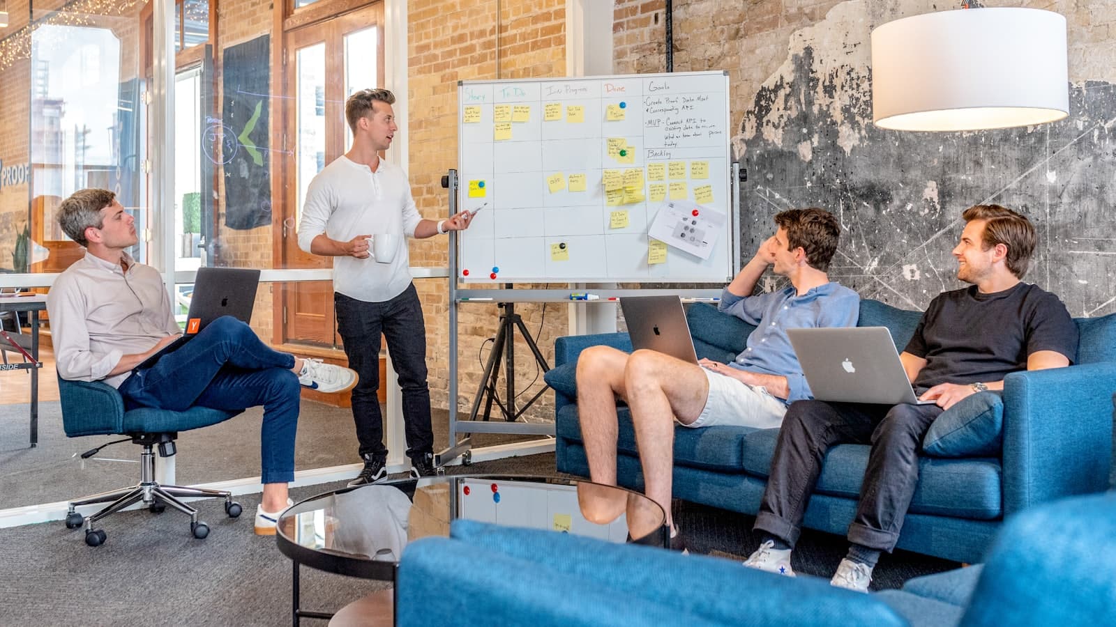 A team working through a plan at a whiteboard